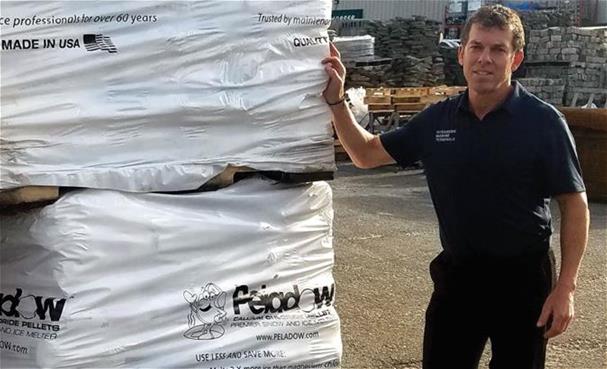 Vic Liotta, President at OMT Marine Terminals, LLC in Oceanside, New York standing next to a pallet of OxyChem PELADOW® Calcium Chloride