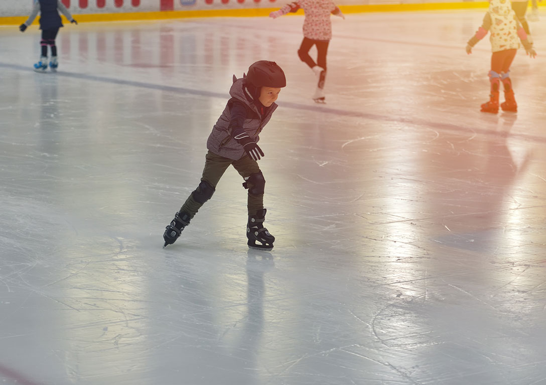 child ice skating on an ice rink - refrigeration - OxyChem calcium chloride