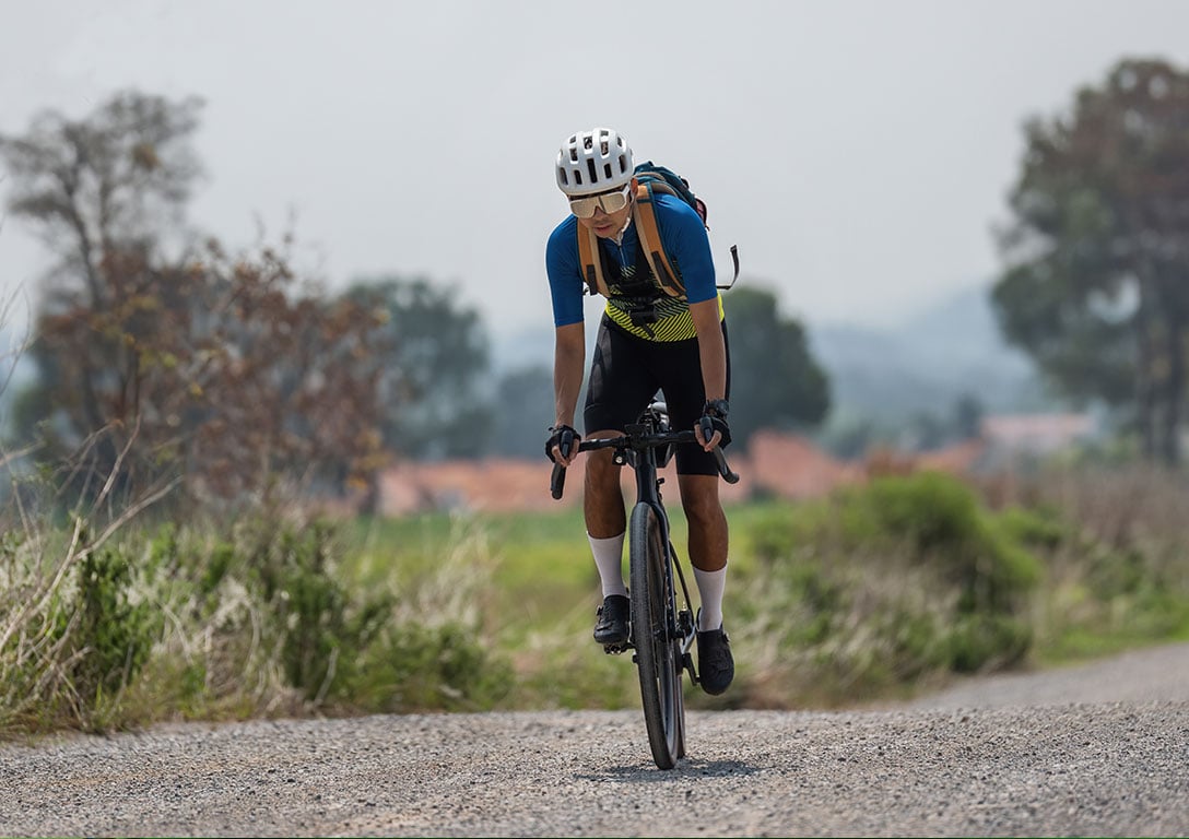 man biking on gravel road - roads: base stabilization - OxyChem calcium chloride