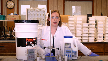 Scientist in lab demonstrating how OxyChem PELADOW Calcium Chloride melts ice faster than magnesium chloride