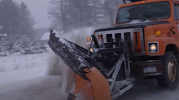 Snowplow truck plowing a snowy road using OxyChem LIQUIDOW Calcium Chloride