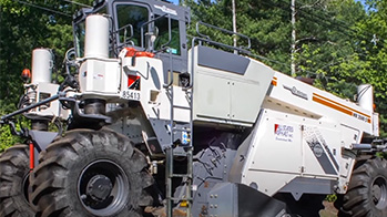 Road grader equipment doing base stabilization on a gravel road using OxyChem Calcium Chloride